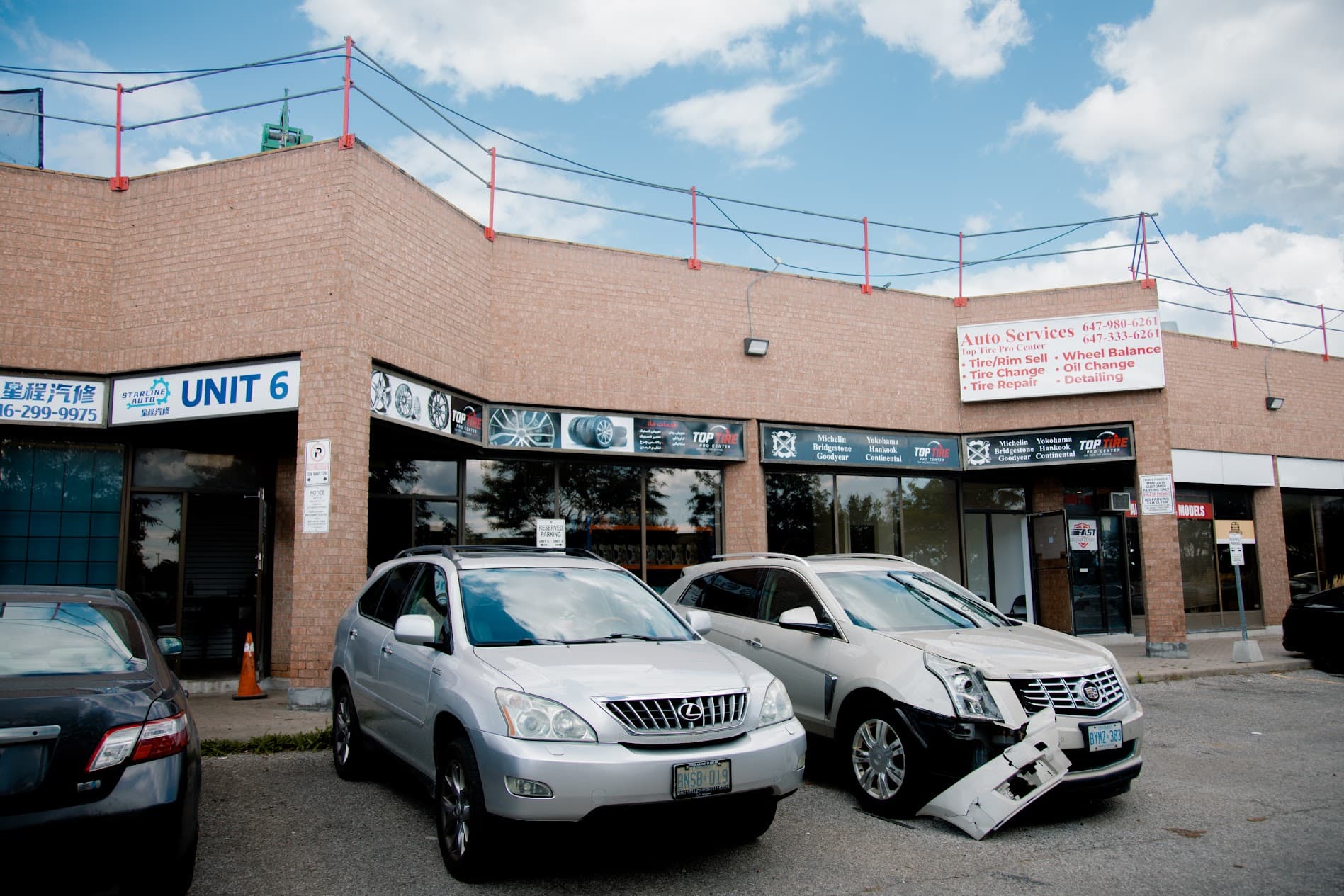 Customer parking and exterior service entrance at Top Tire Pro Center