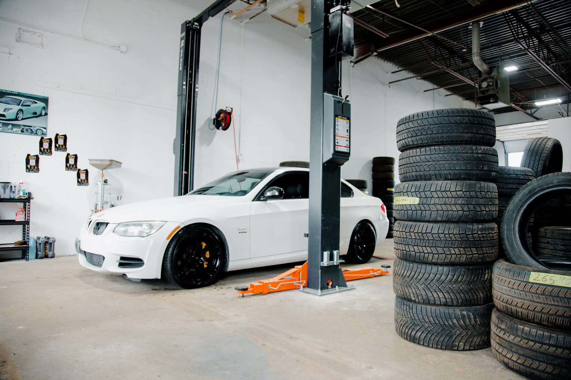 Vehicle inspection on dual-post hydraulic lift with performance wheel fitment